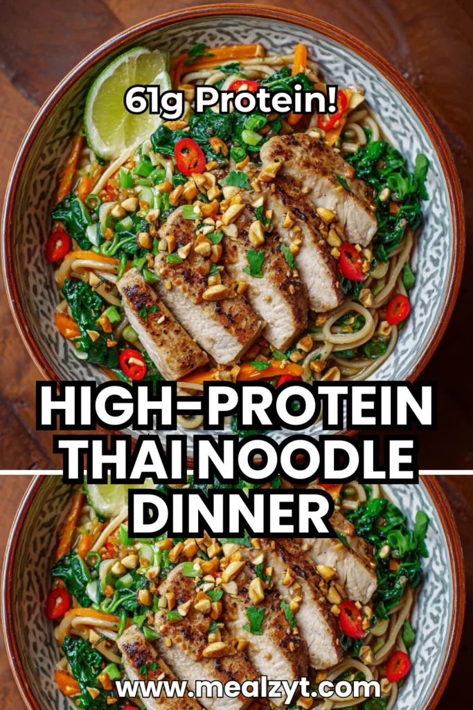 High protein Thai noodle dinner with 61g protein featuring thinly sliced chicken breast, pink shrimp, scrambled eggs, shelled edamame, rice noodles, julienned carrots, sliced red bell peppers, Chinese broccoli, shredded cabbage all coated in creamy peanut sauce made from natural peanut butter, tamari, oyster sauce, sriracha, garnished with crushed roasted peanuts, green onions, cilantro, lime wedges